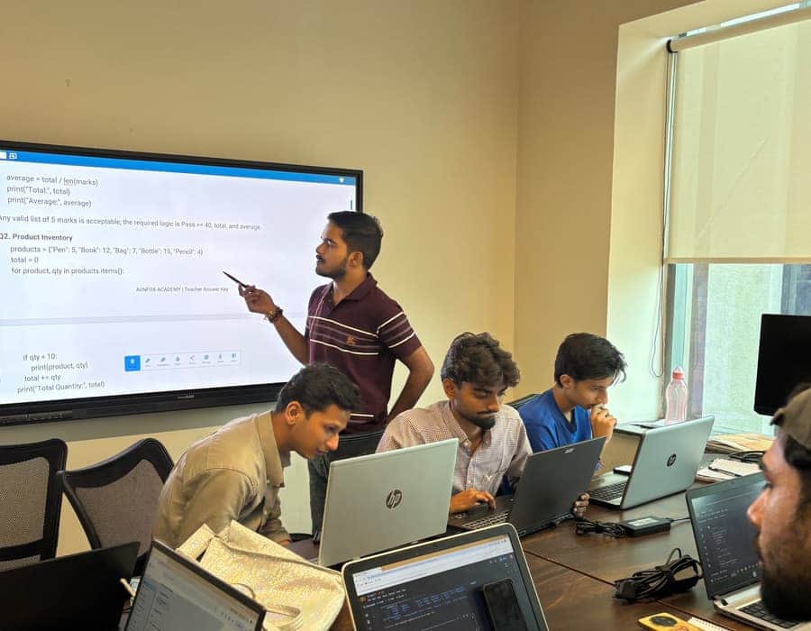 A Python exercise from our own answer key on the classroom screen, with a trainer talking it through