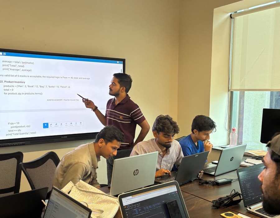 A Python exercise from our own answer key on the classroom screen, with a trainer talking it through